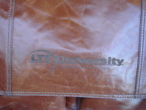 Laser etched leater bag with corporate logo for employee anniversary.